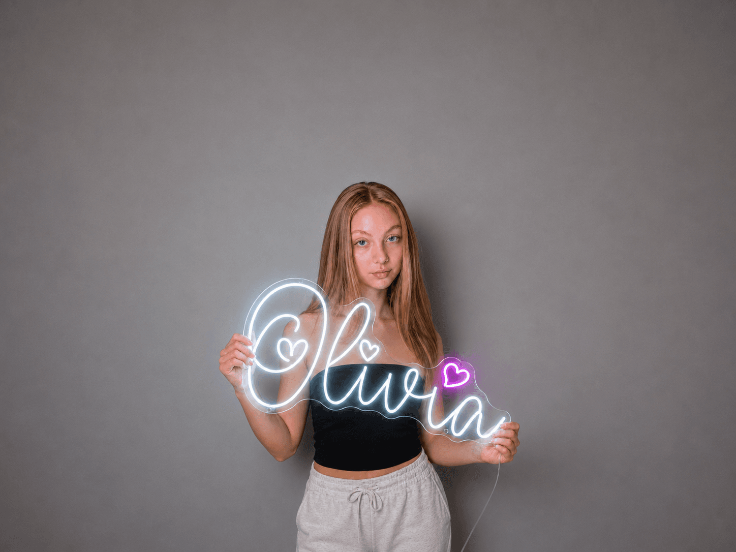 Pink custom LED neon sign glowing on a dark bedroom wall